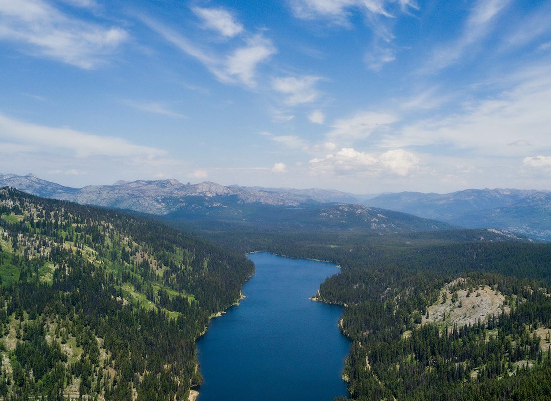 About Our Agency - Aerial View of a Forest and River in Idaho